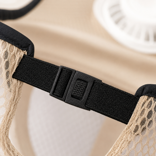 Close-up of a beige mesh garment with a black adjustable elastic band and plastic buckle.